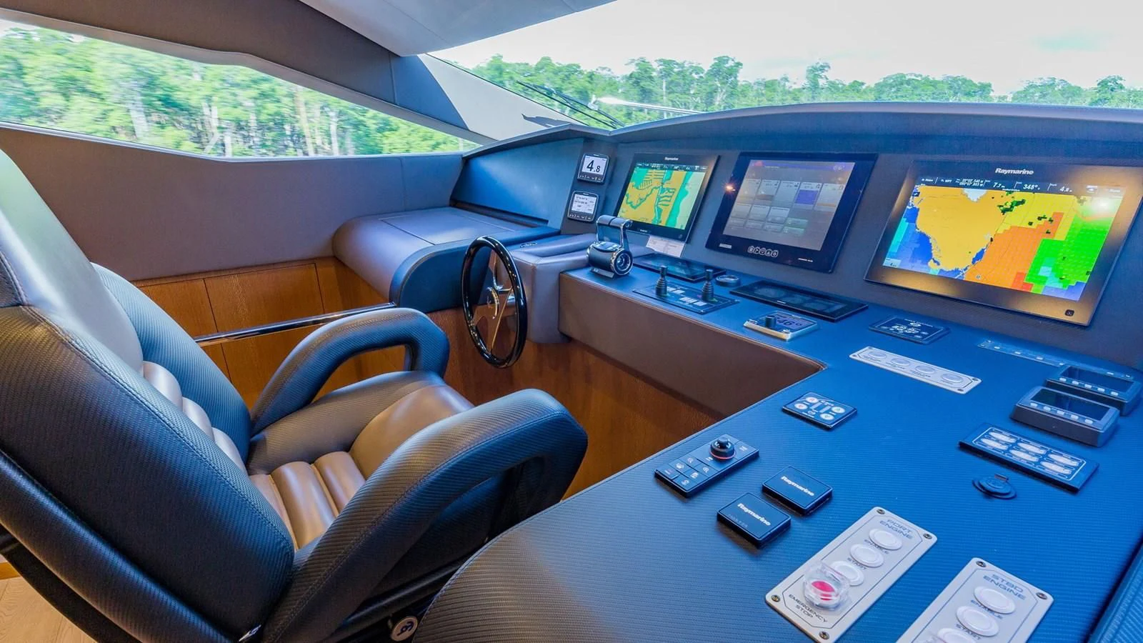 a table with many remote controls on it aboard GOLDEN 3 Yacht for Sale