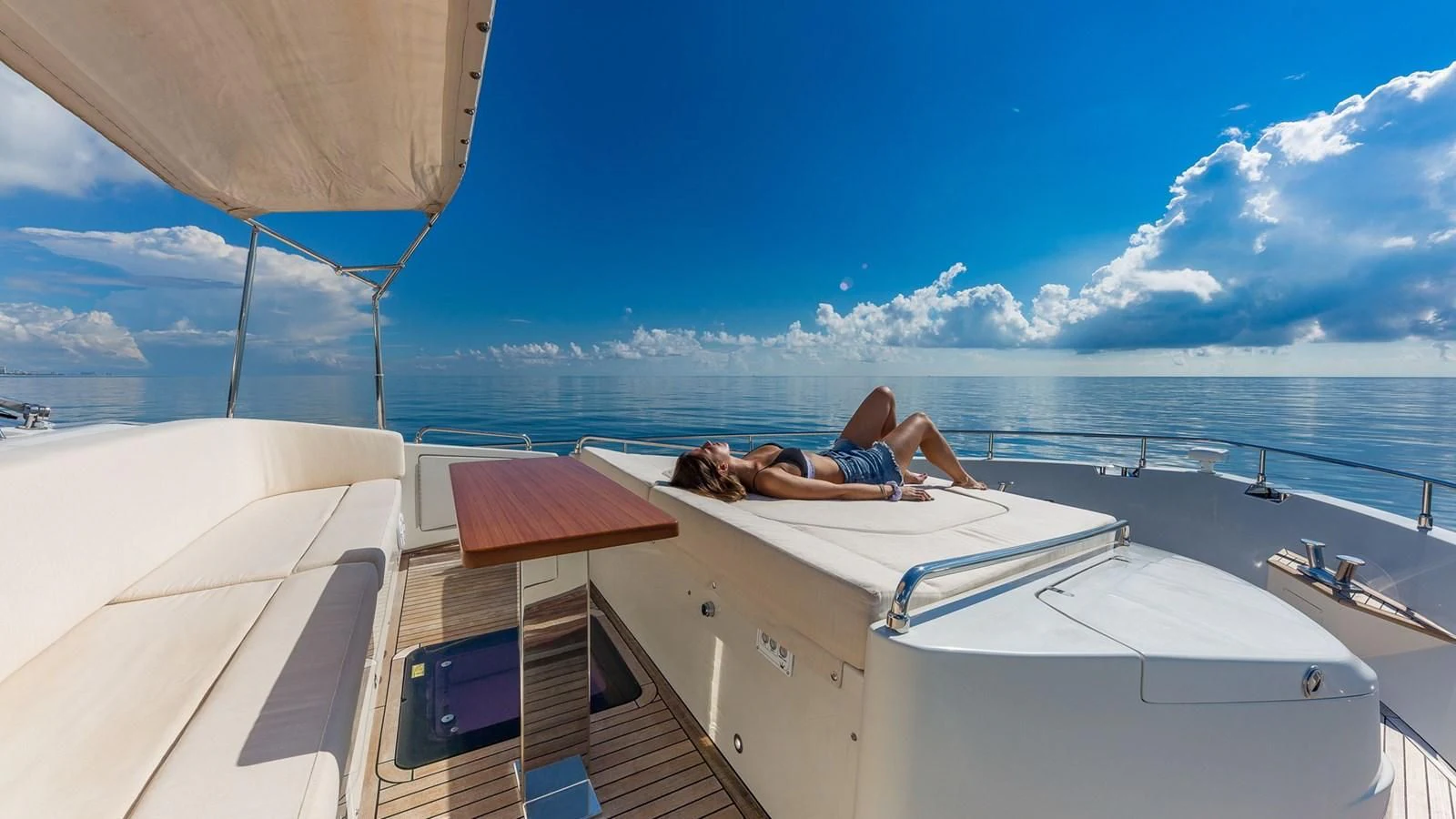 a person lying on a boat aboard GOLDEN 3 Yacht for Sale