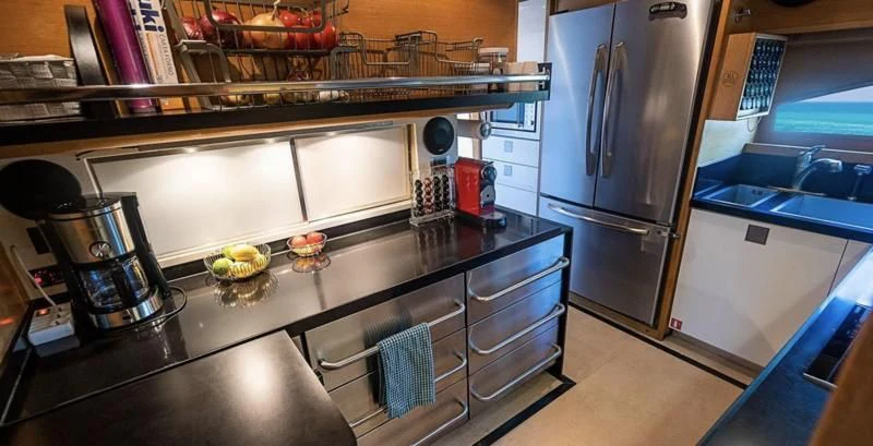 a kitchen with stainless steel appliances aboard PATRON Yacht for Sale