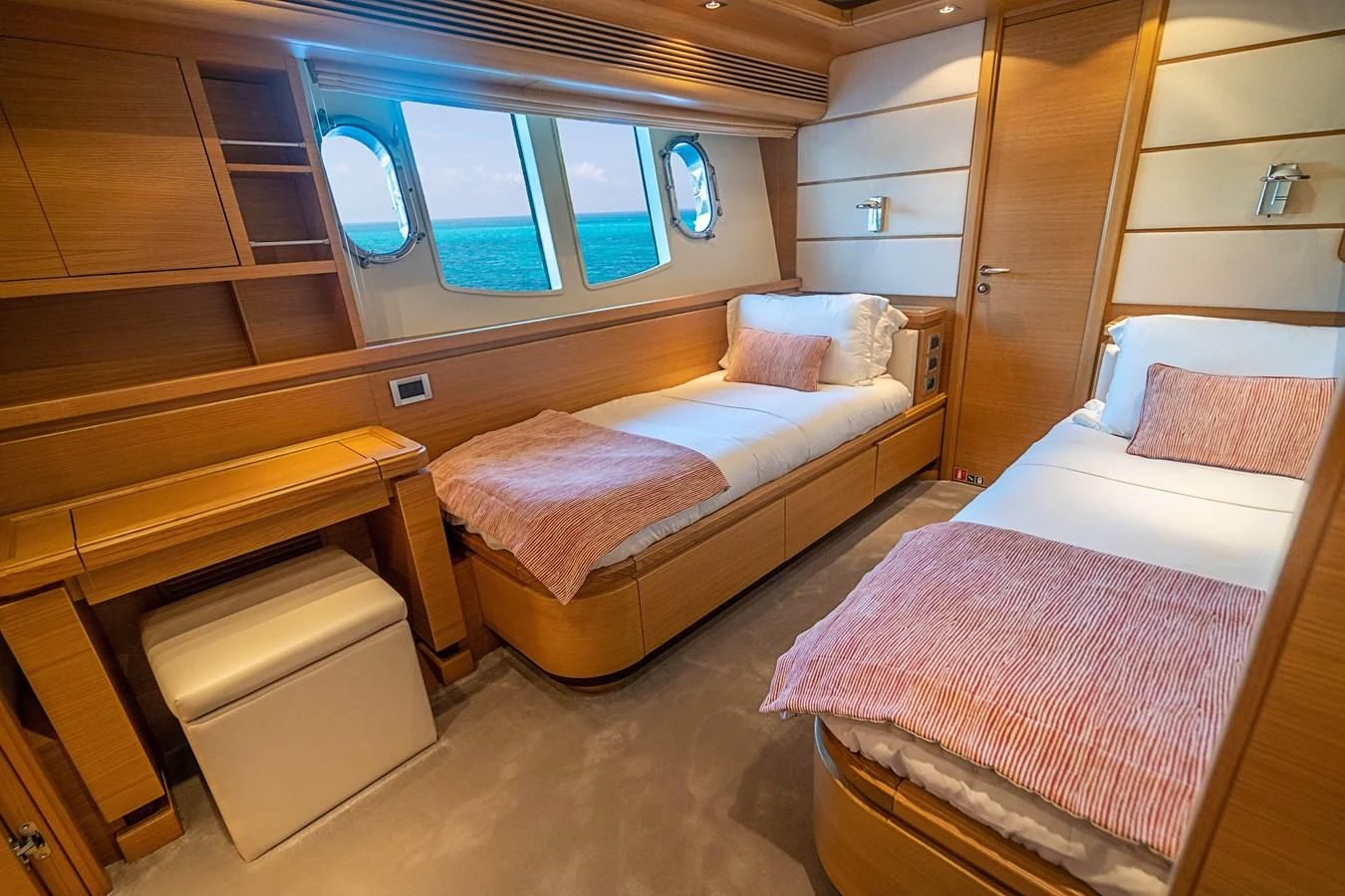 a room with two beds aboard PATRON Yacht for Sale