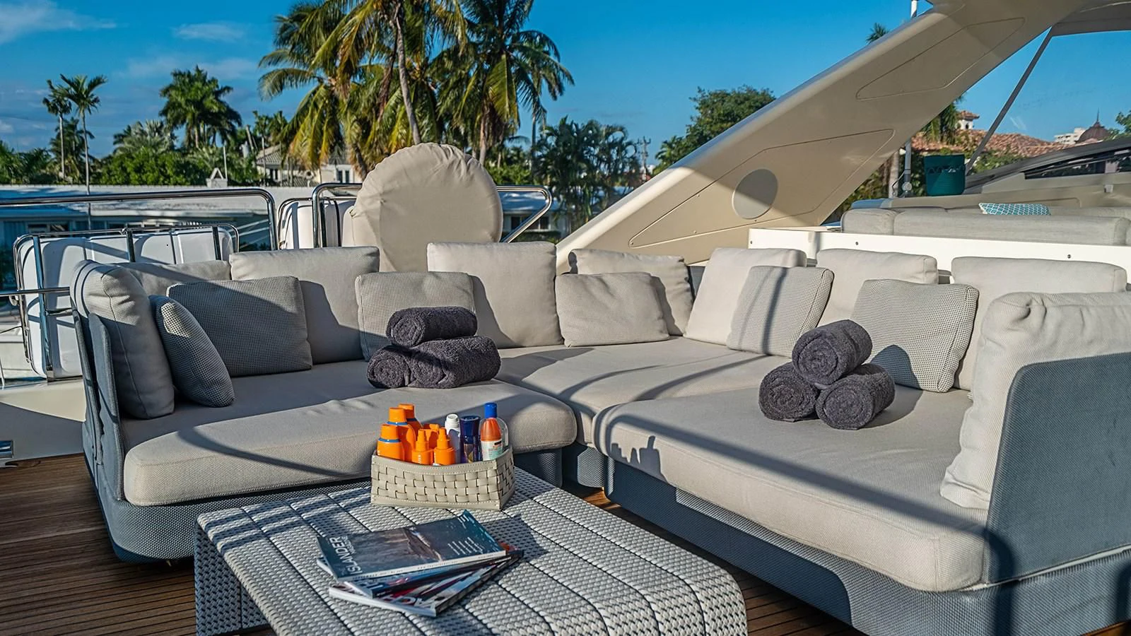 a large white couch with a blue roof and a table with a drink on it aboard PATRON Yacht for Sale