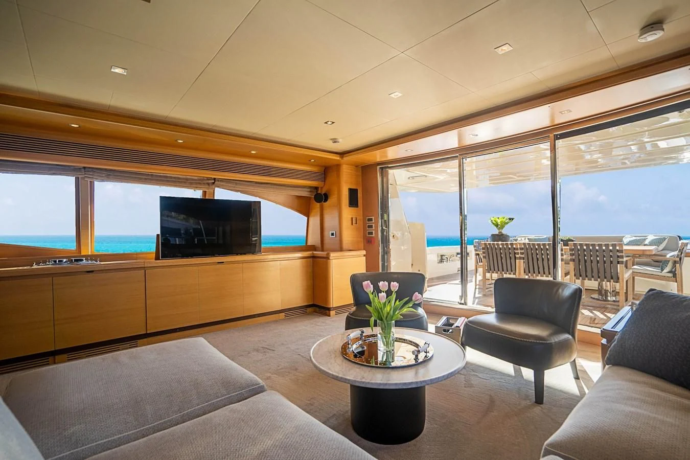 a living room with a large tv aboard PATRON Yacht for Sale