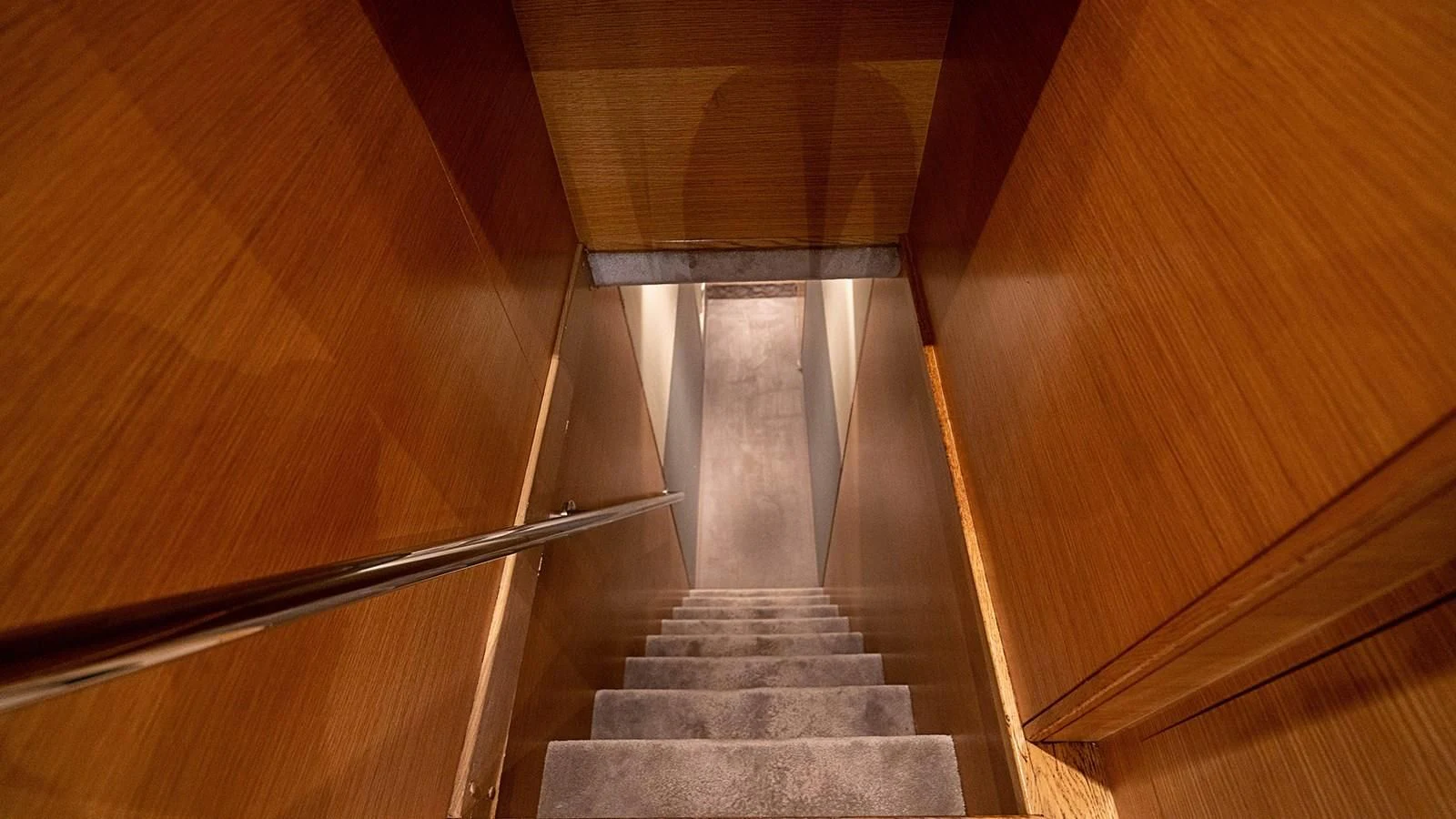a staircase with a metal railing aboard PATRON Yacht for Sale
