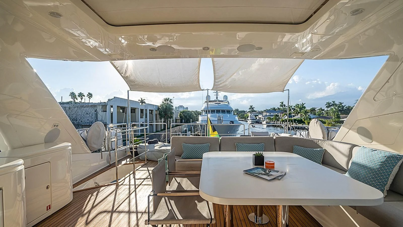 a large white tent with a table and chairs and a view of the water aboard PATRON Yacht for Sale