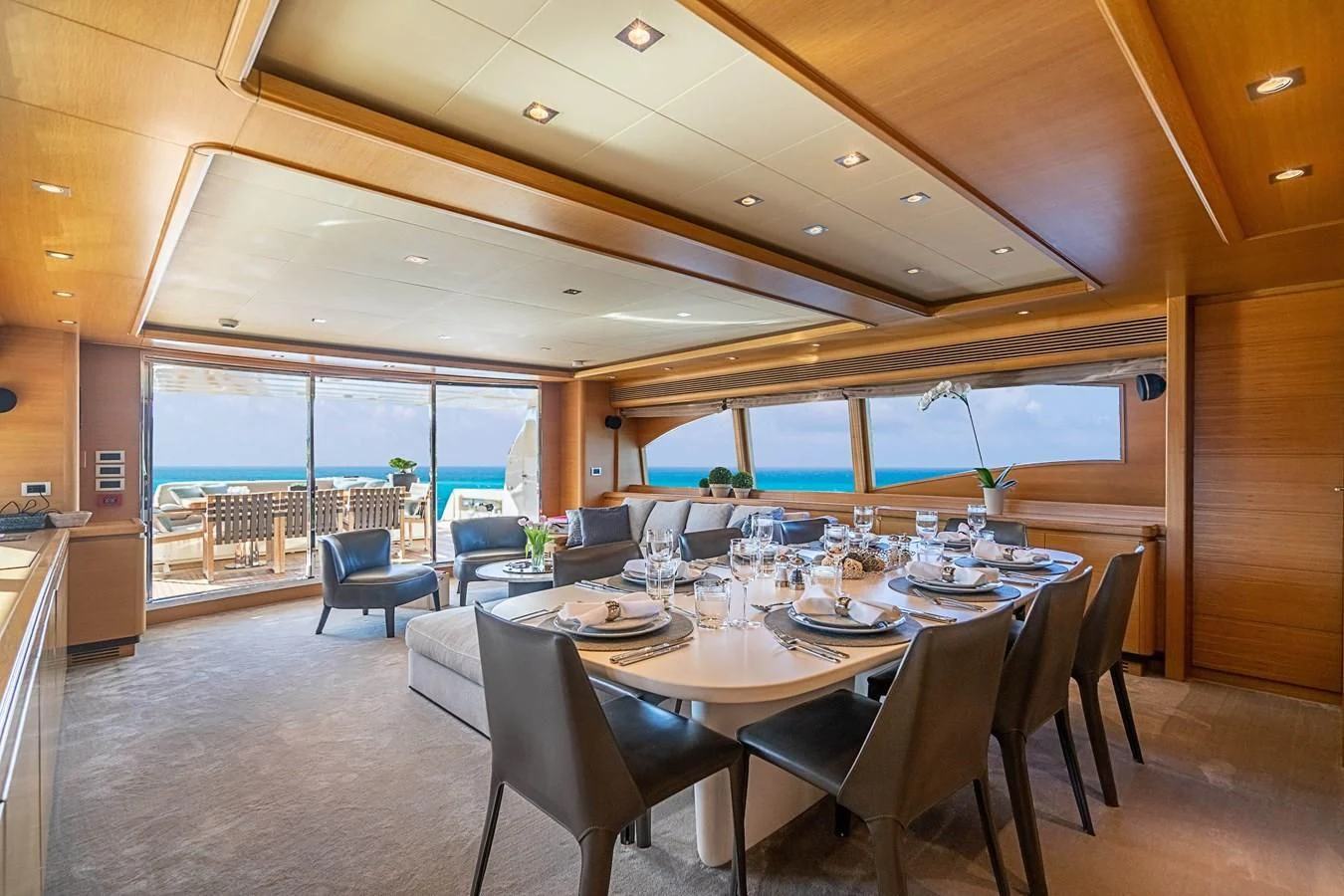 a large dining room with a large window aboard PATRON Yacht for Sale