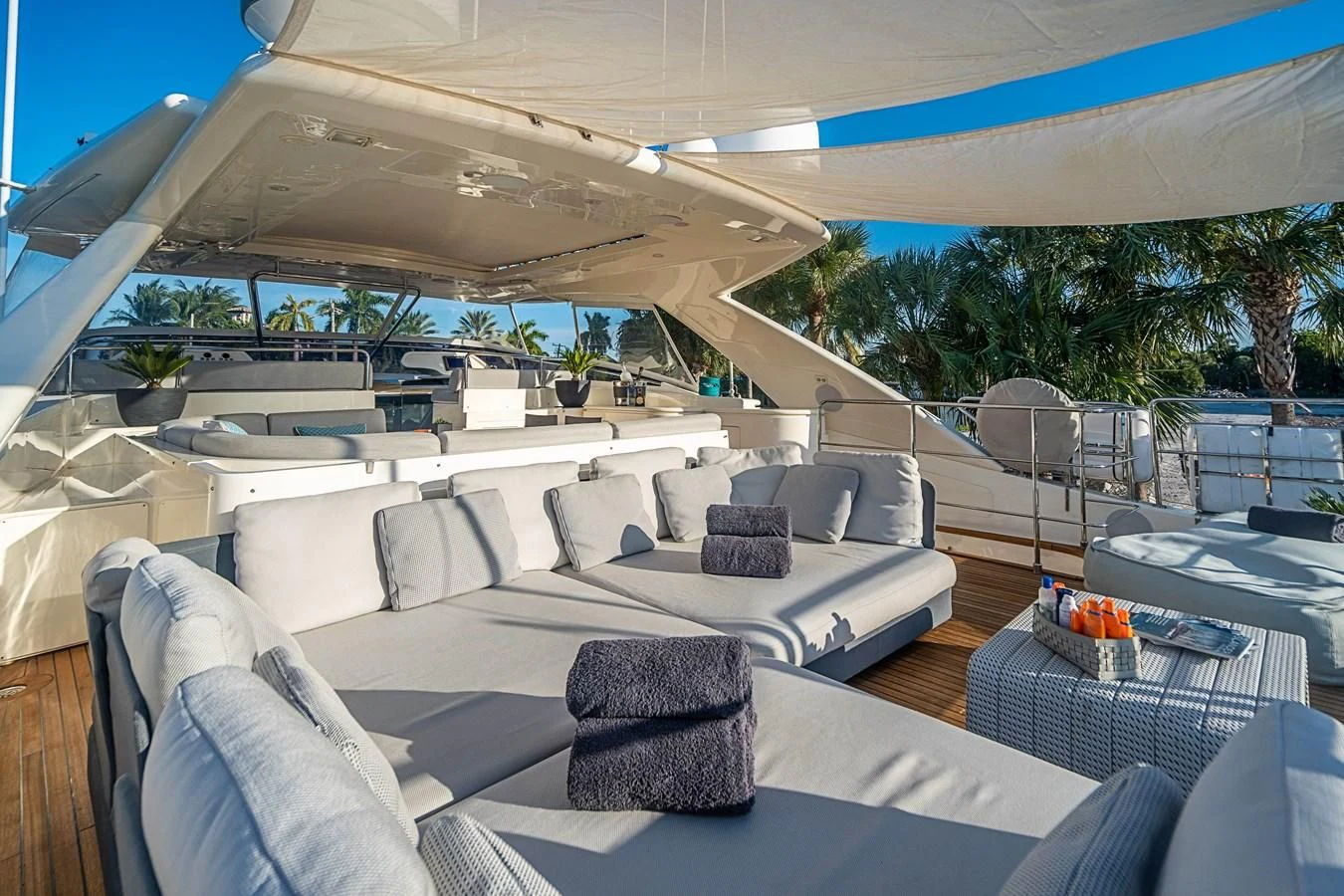 a large lounge area with a large lounge chair and a large white lounge chair aboard PATRON Yacht for Sale
