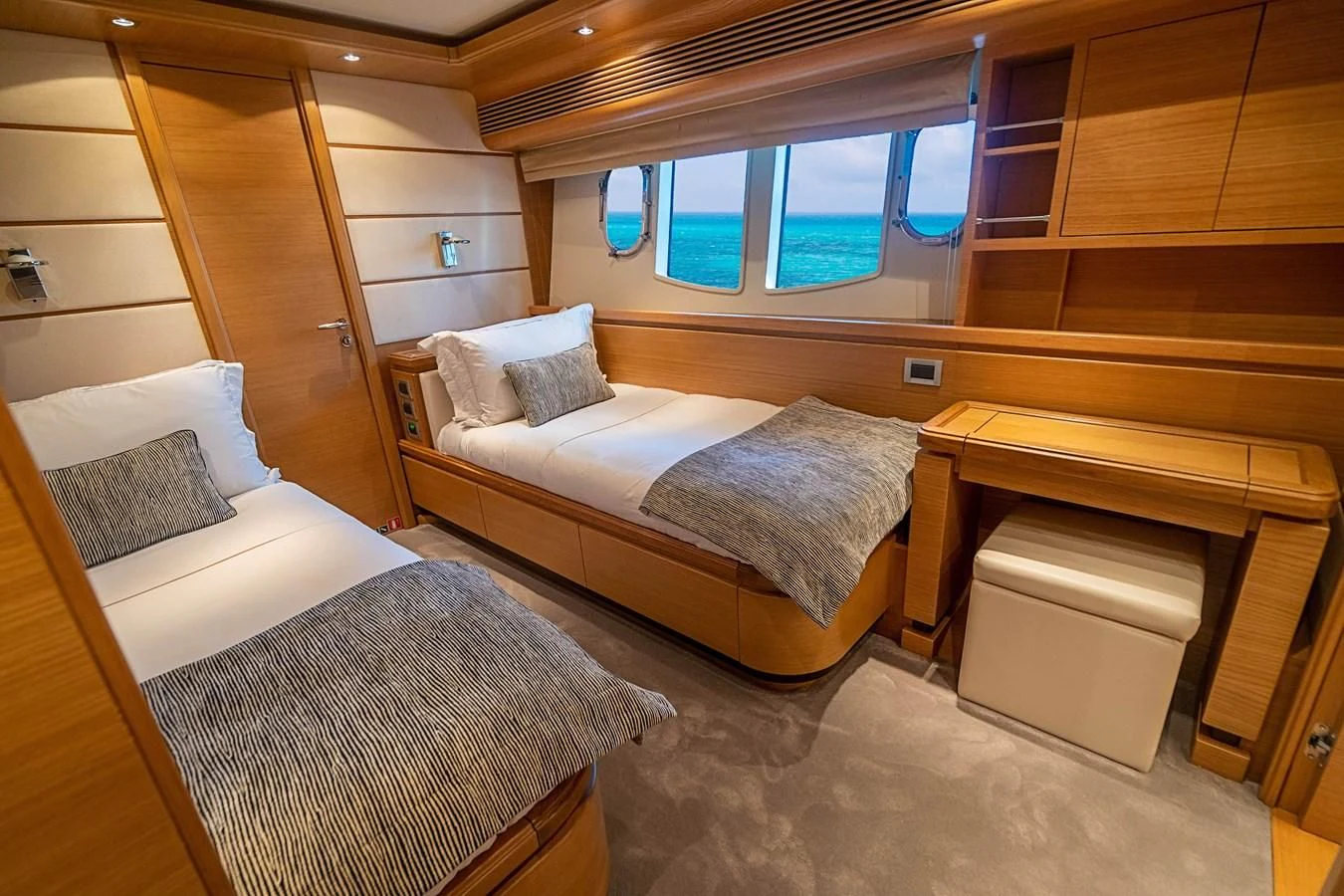 a room with a bed and a bench aboard PATRON Yacht for Sale