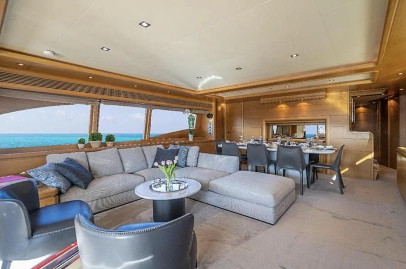 a living room with a couch and a table aboard PATRON Yacht for Sale