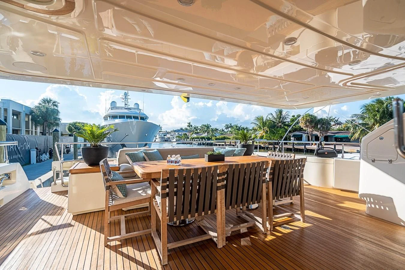 a deck with tables and chairs aboard PATRON Yacht for Sale