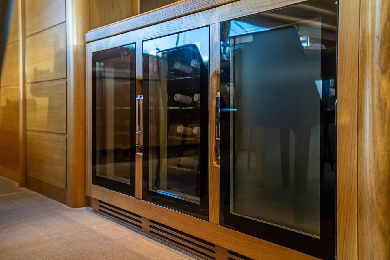 a cabinet with a glass door aboard PATRON Yacht for Sale