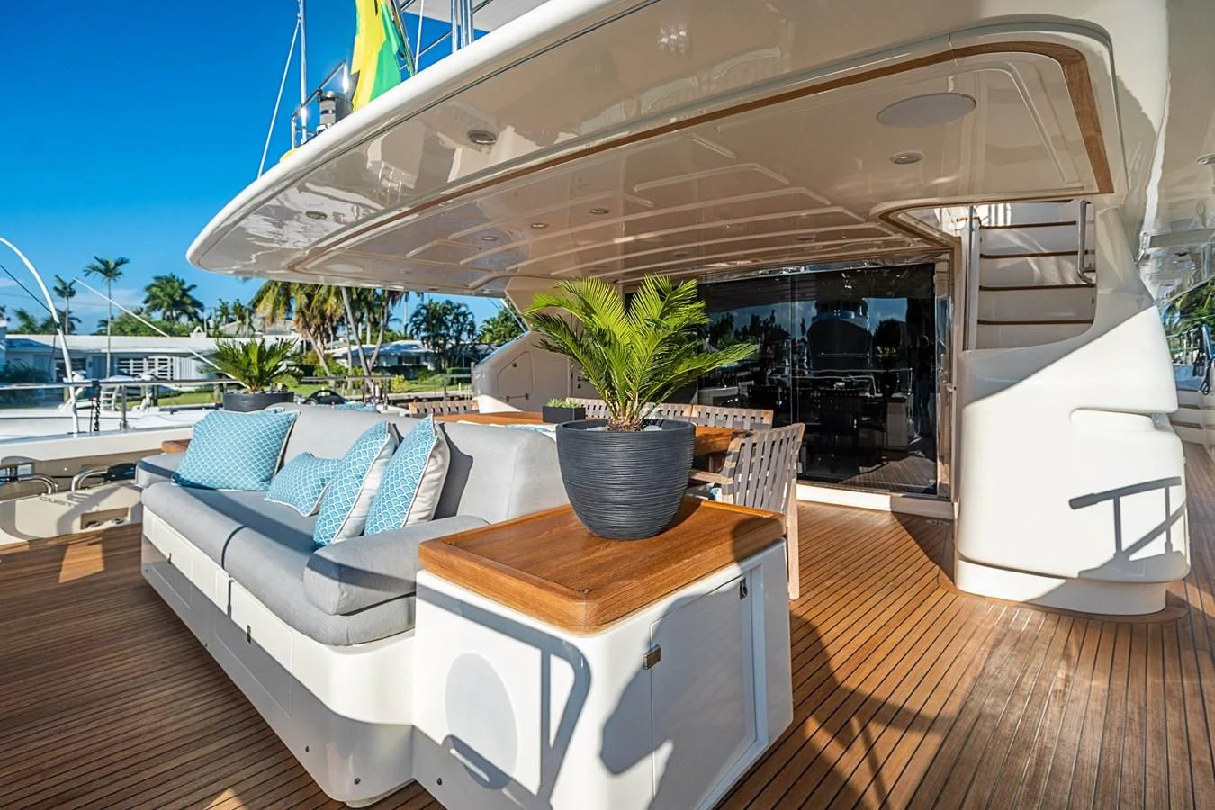 a room with a couch and a table with a plant on it aboard PATRON Yacht for Sale