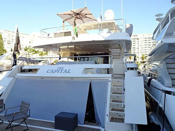 a large white boat with a satellite dish on top aboard PATRON Yacht for Sale