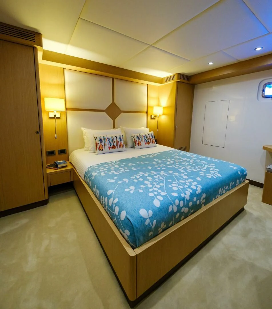 a bed with blue sheets aboard OTTAWA IV Yacht for Sale