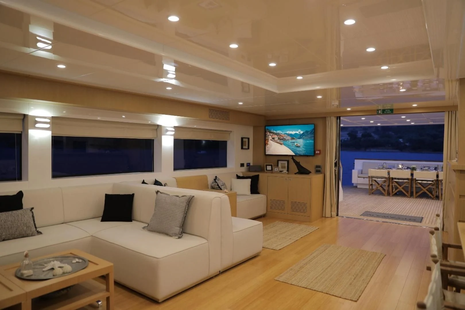 a living room with a large screen aboard OTTAWA IV Yacht for Sale