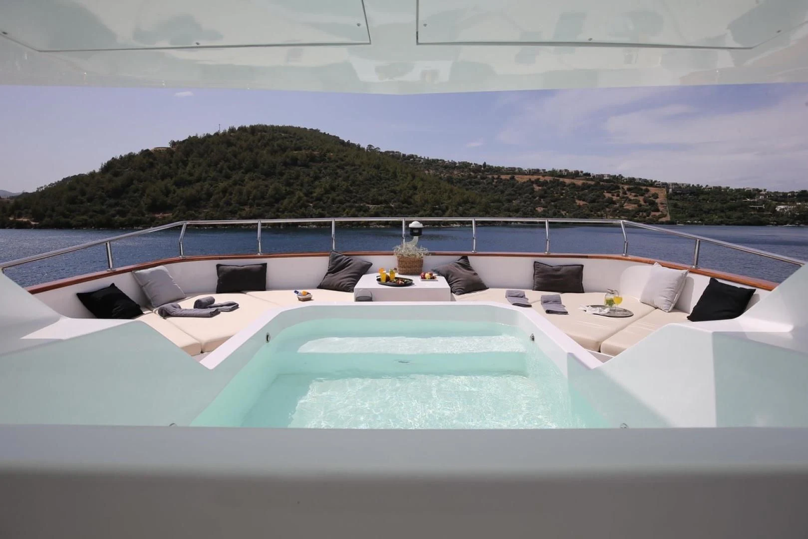 a swimming pool with a view of the mountains aboard OTTAWA IV Yacht for Sale