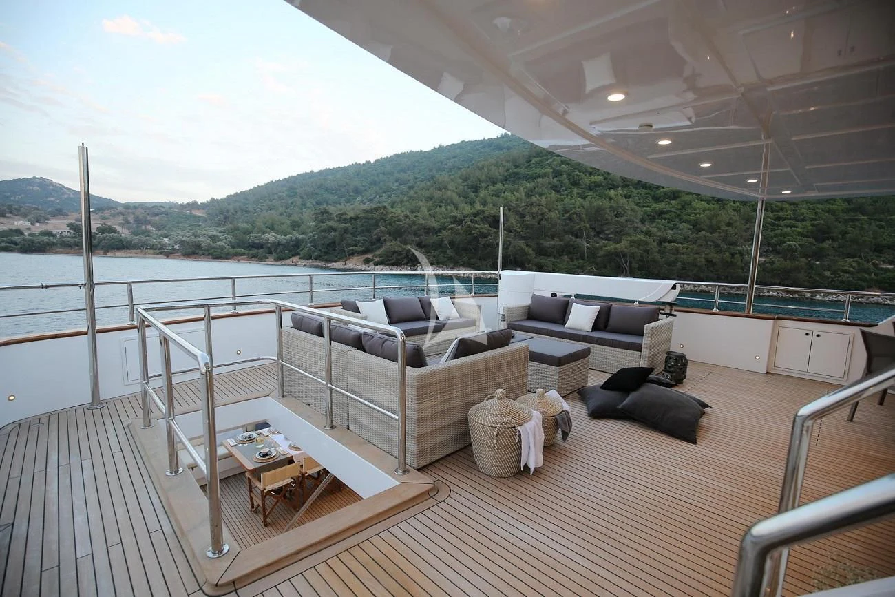 a deck with a couch and a table on it aboard OTTAWA IV Yacht for Sale