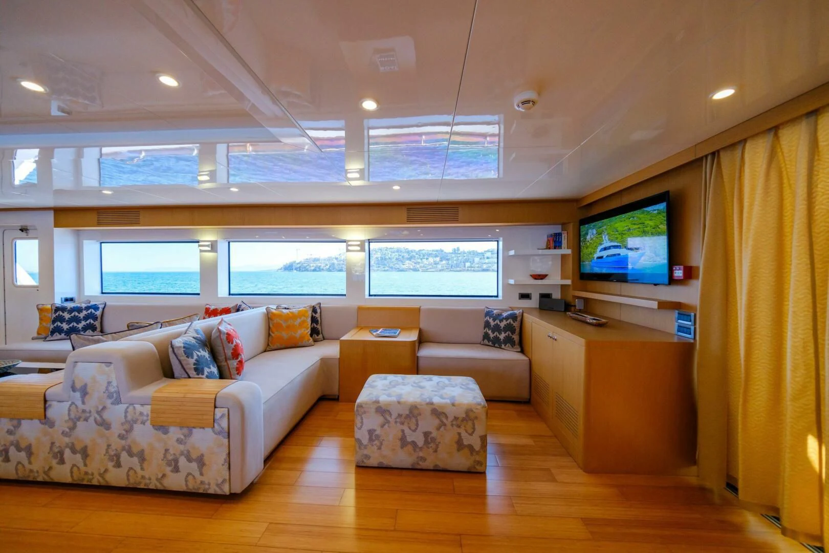 a living room with a large screen aboard OTTAWA IV Yacht for Sale