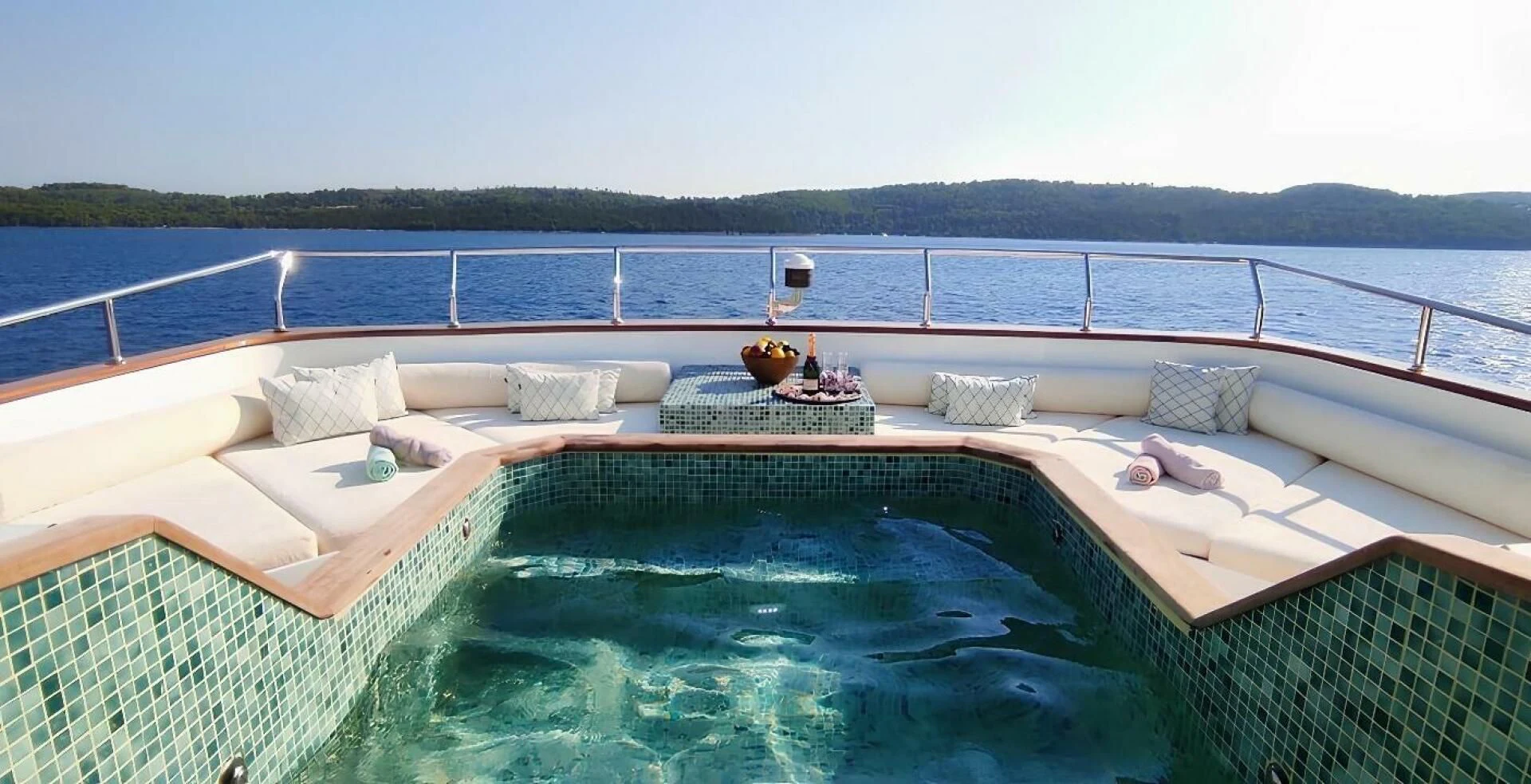 a pool with a couch and a table on it aboard OTTAWA IV Yacht for Sale