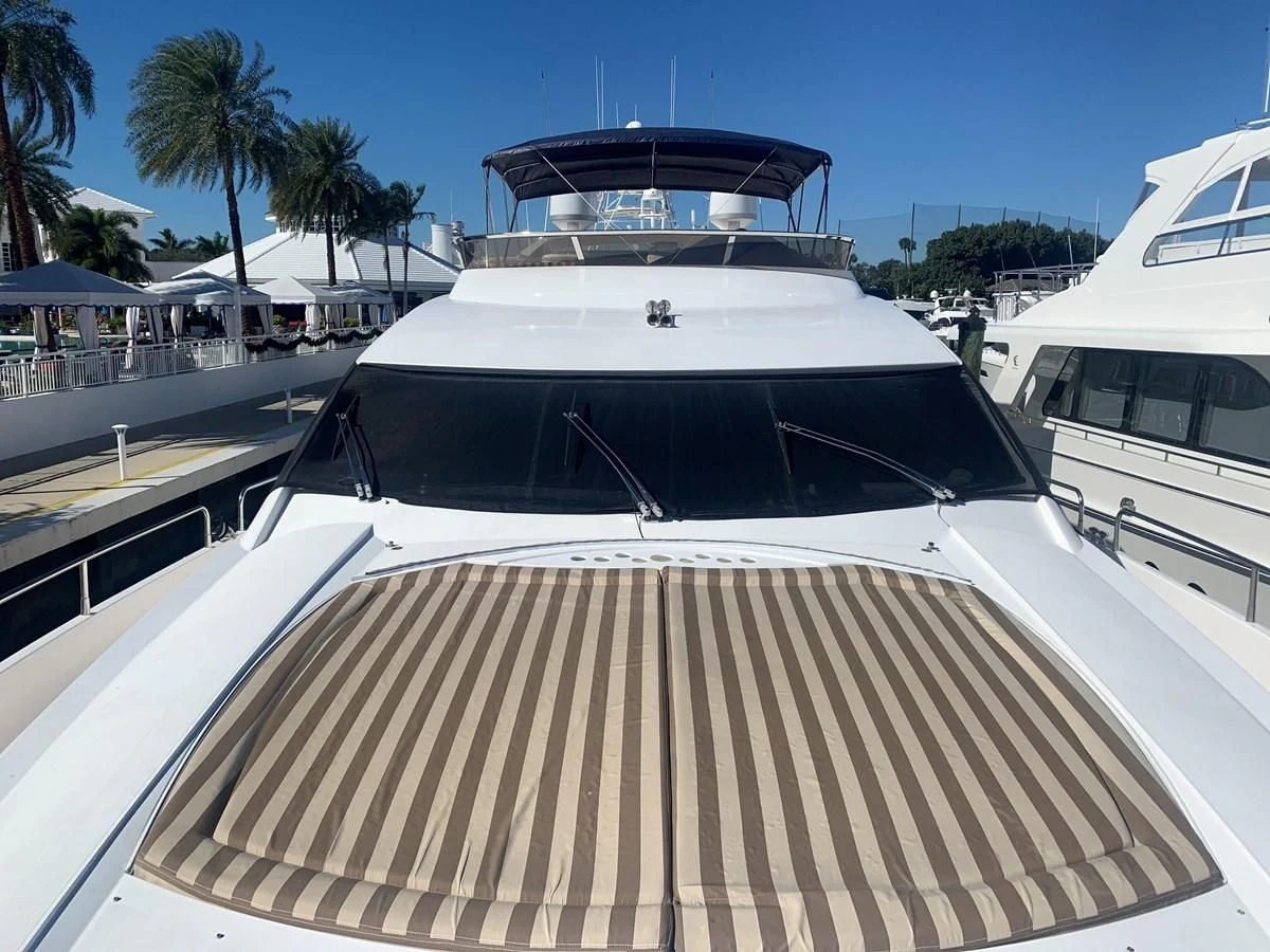 a white yacht at a dock aboard MY MEDICINE Yacht for Sale