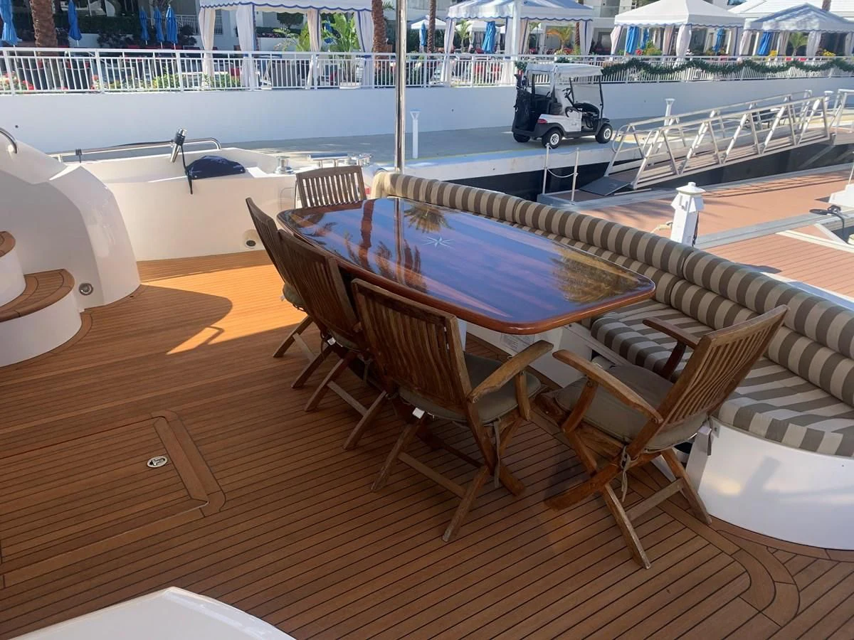 a pool table and chairs on a deck aboard MY MEDICINE Yacht for Sale