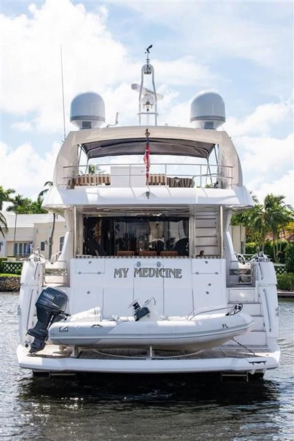 a white boat with a blue roof aboard MY MEDICINE Yacht for Sale