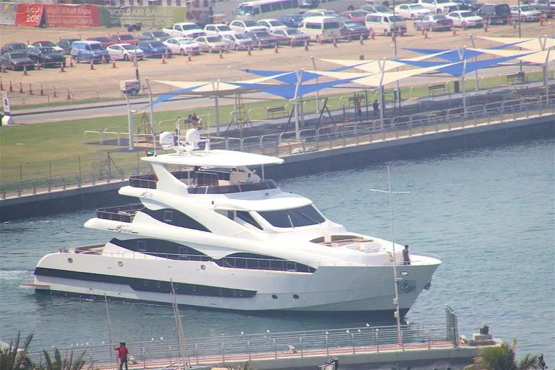a white yacht docked at a pier aboard STARDOM Yacht for Sale