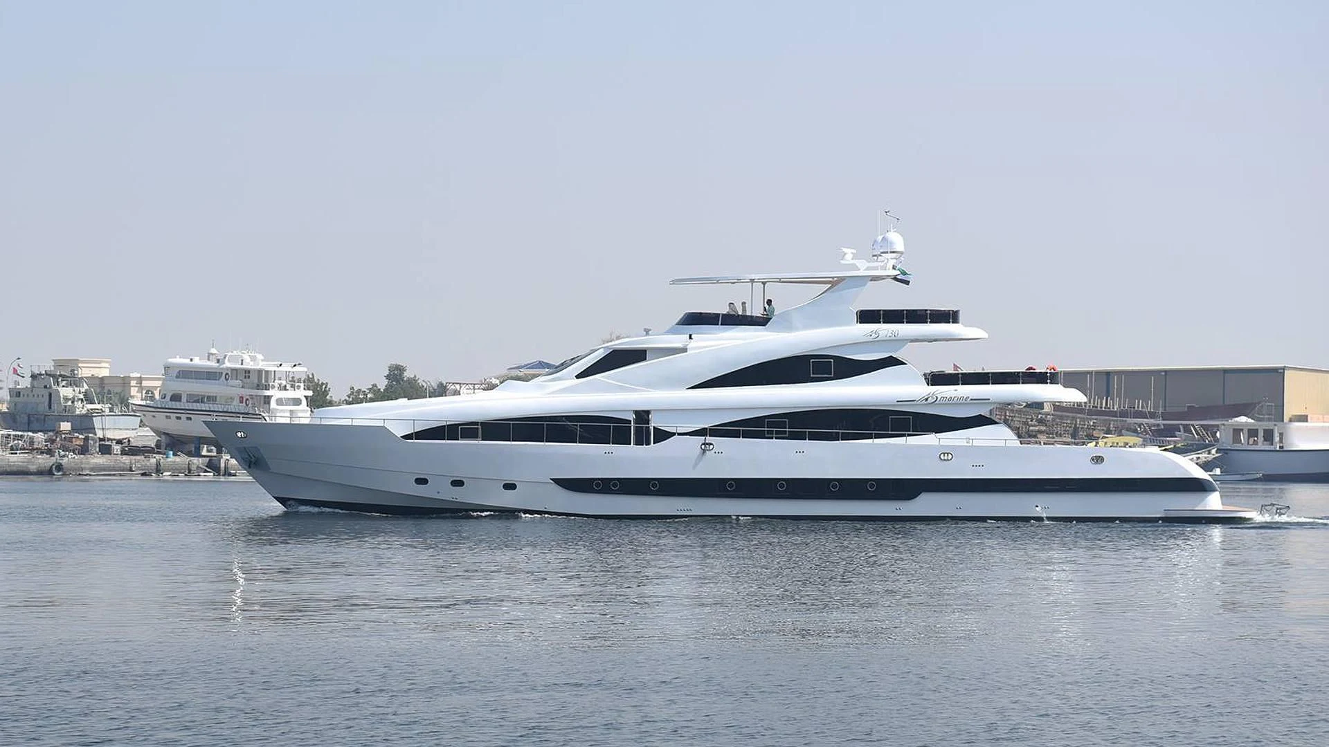 a white yacht in a harbor aboard STARDOM Yacht for Sale