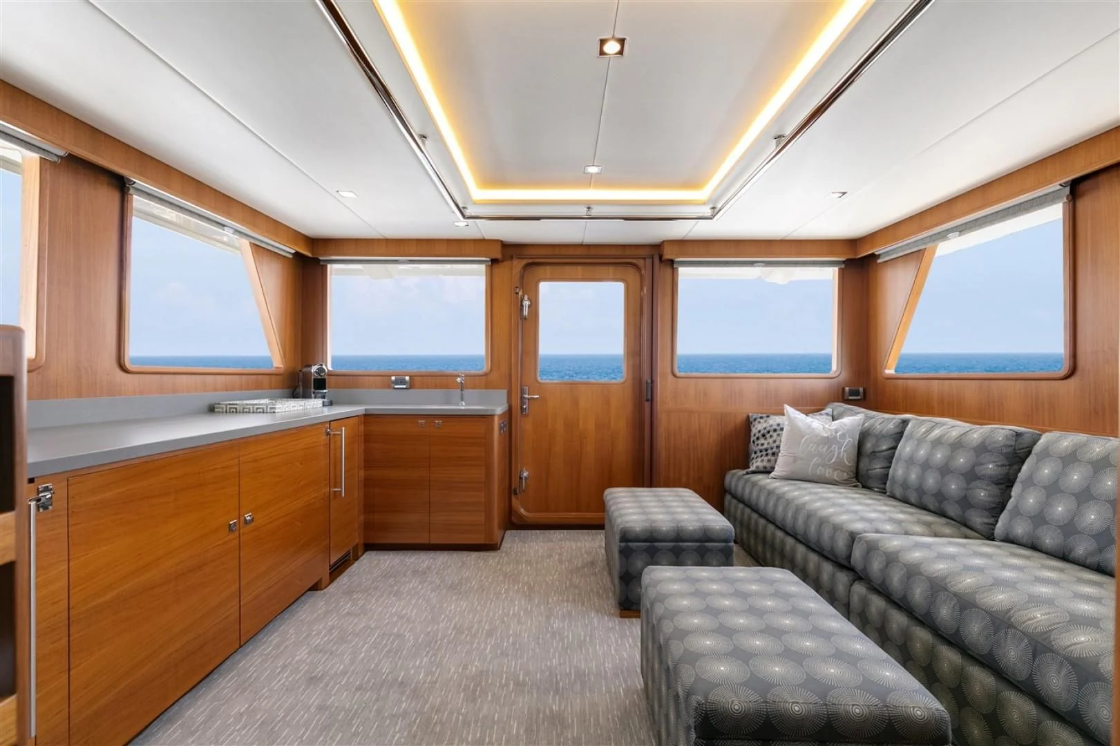 a living room with a couch and a table aboard BLUE CHIP Yacht for Sale