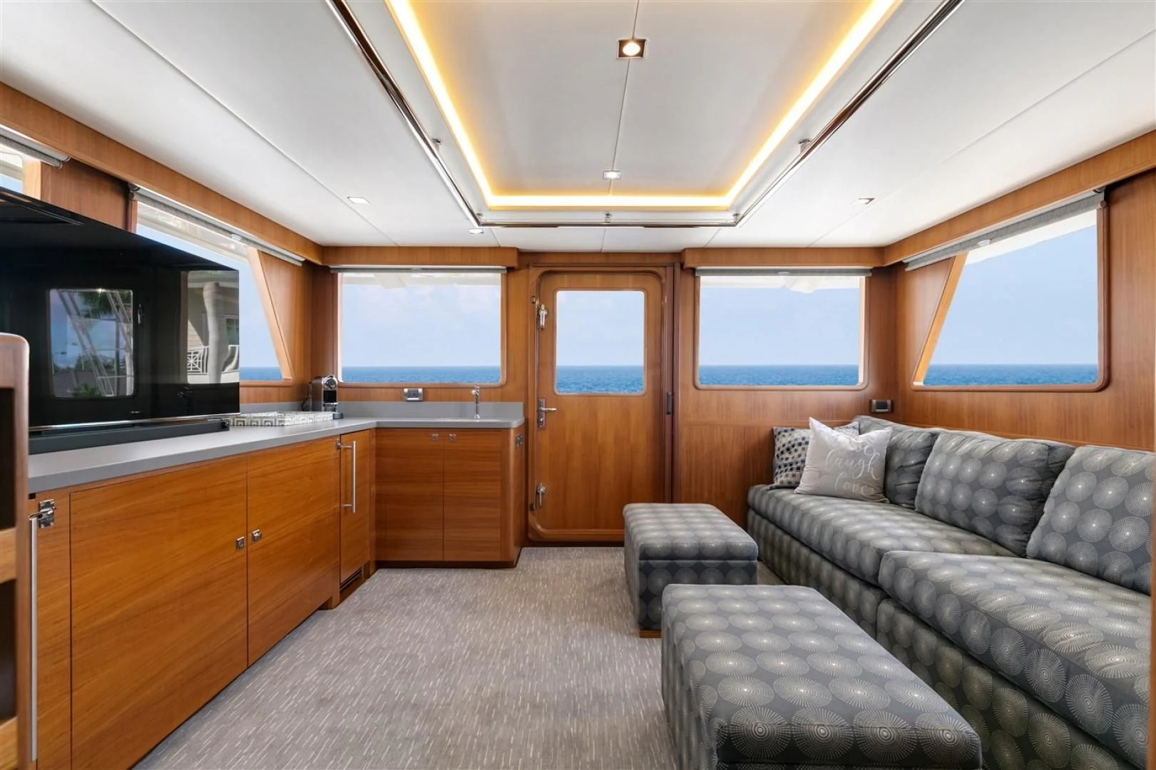 a living room with a couch and a tv aboard BLUE CHIP Yacht for Sale