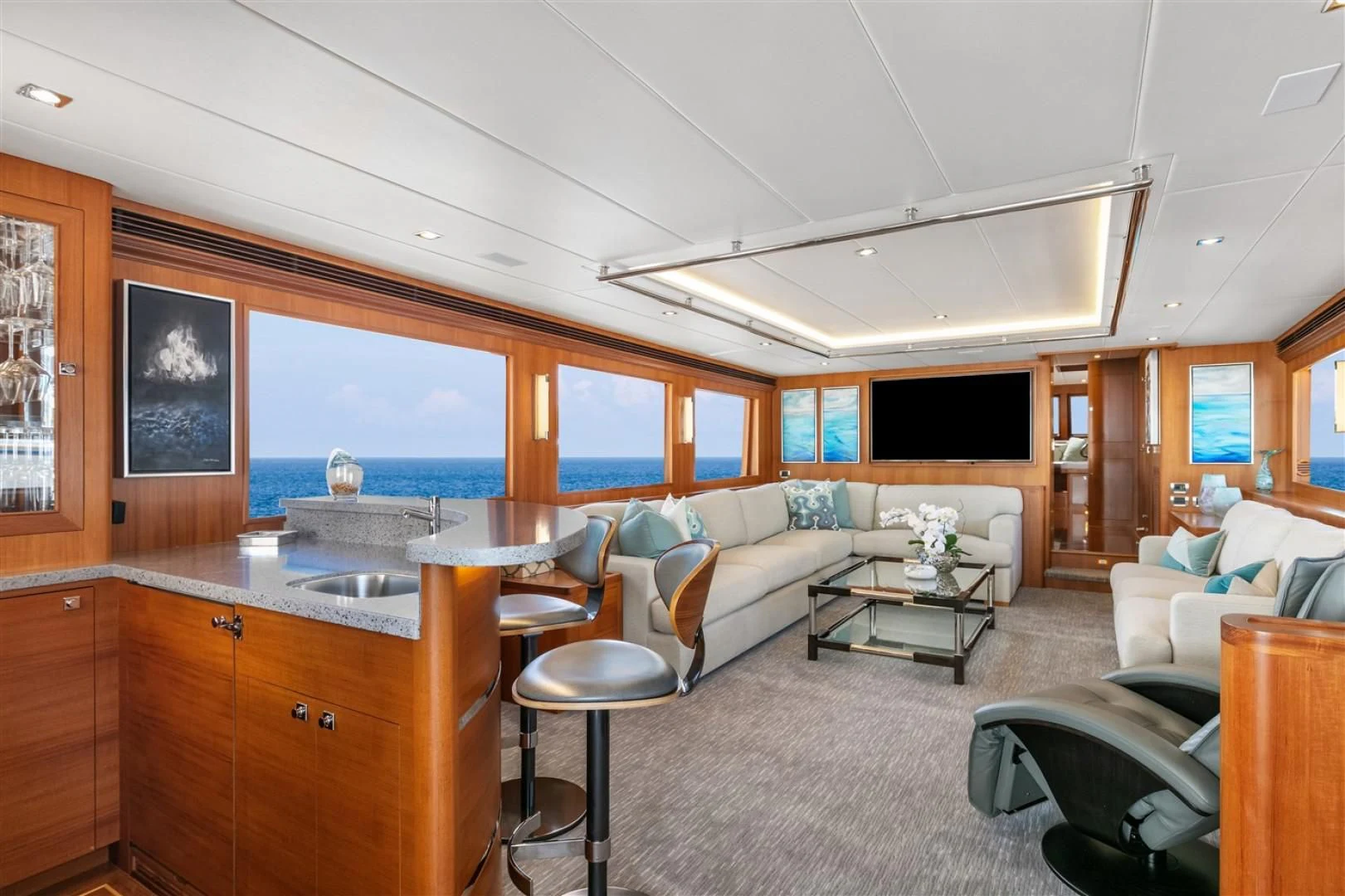 a living room with a kitchen and dining area aboard BLUE CHIP Yacht for Sale