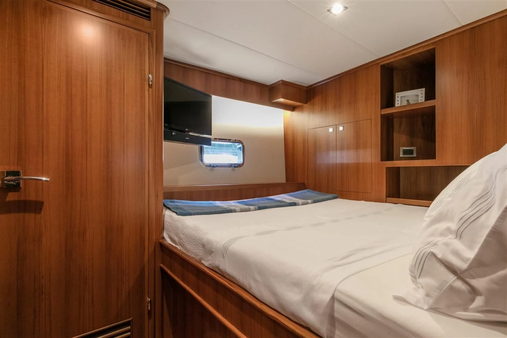 a room with a bed and a television aboard BLUE CHIP Yacht for Sale