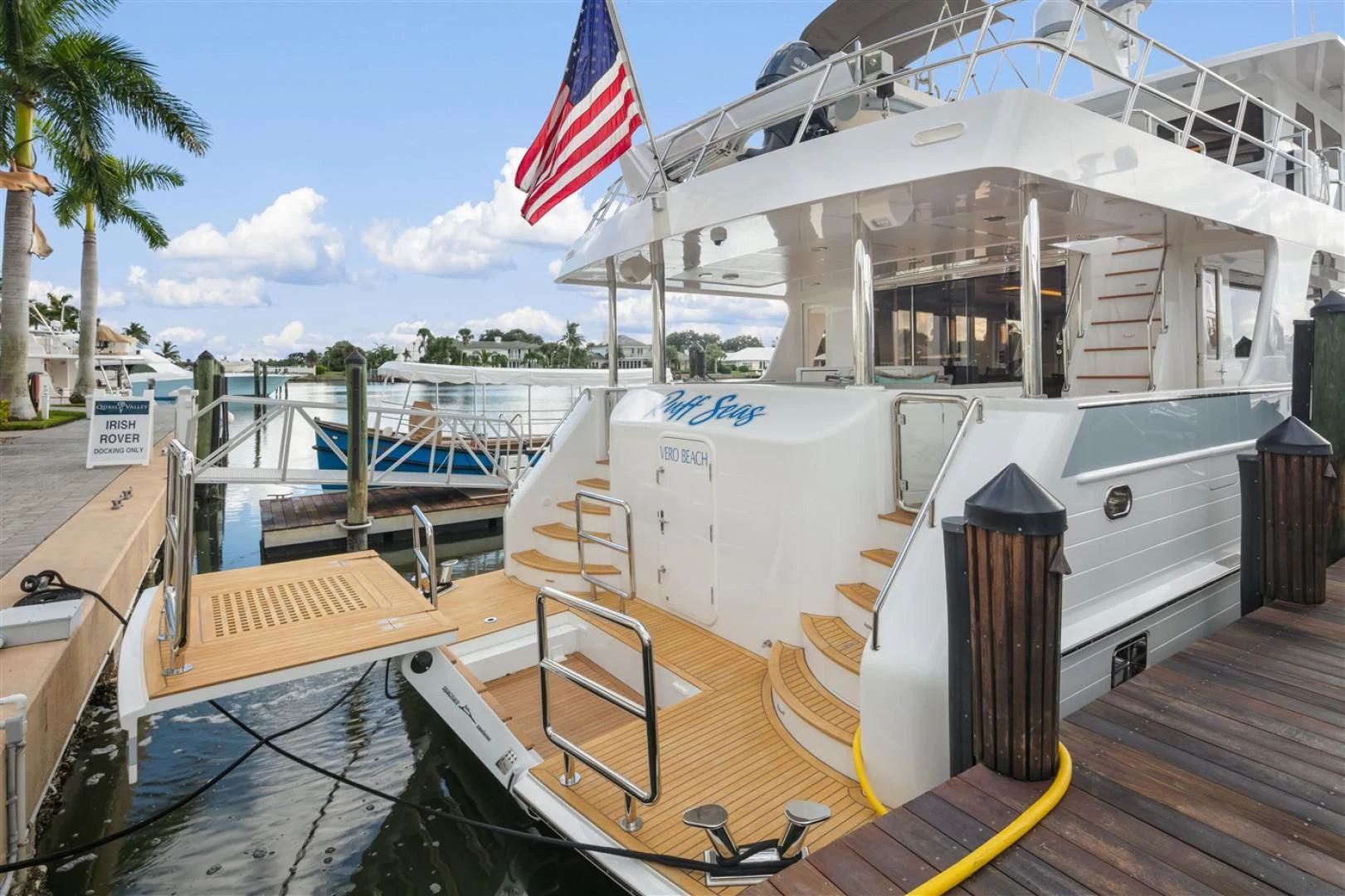 a boat with a flag on the front aboard BLUE CHIP Yacht for Sale