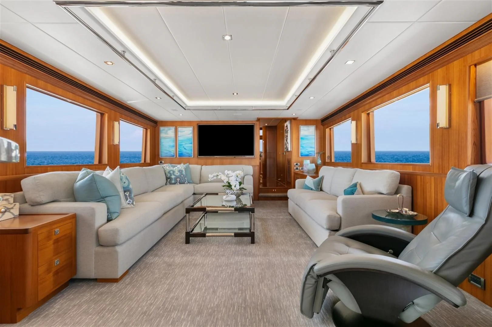 a living room with a couch and a coffee table aboard BLUE CHIP Yacht for Sale