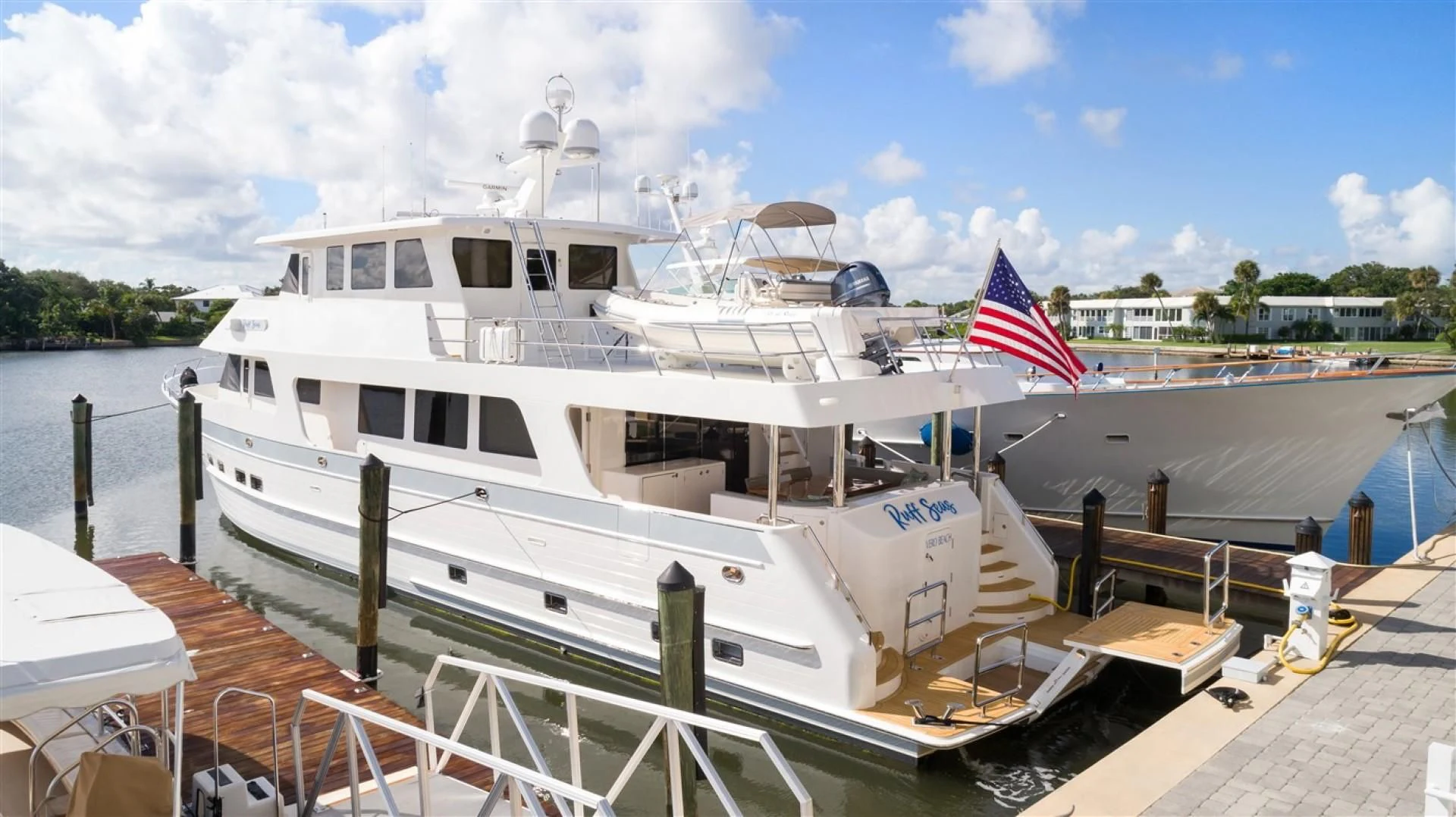 a large white boat on a dock aboard BLUE CHIP Yacht for Sale