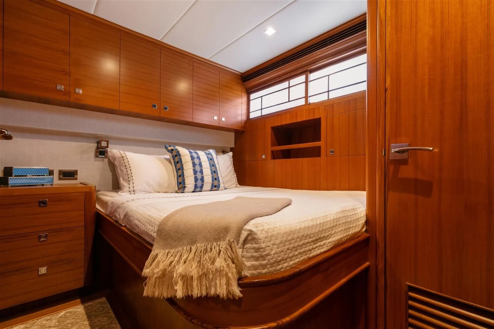 a bed with a white sheet and pillows on it aboard BLUE CHIP Yacht for Sale