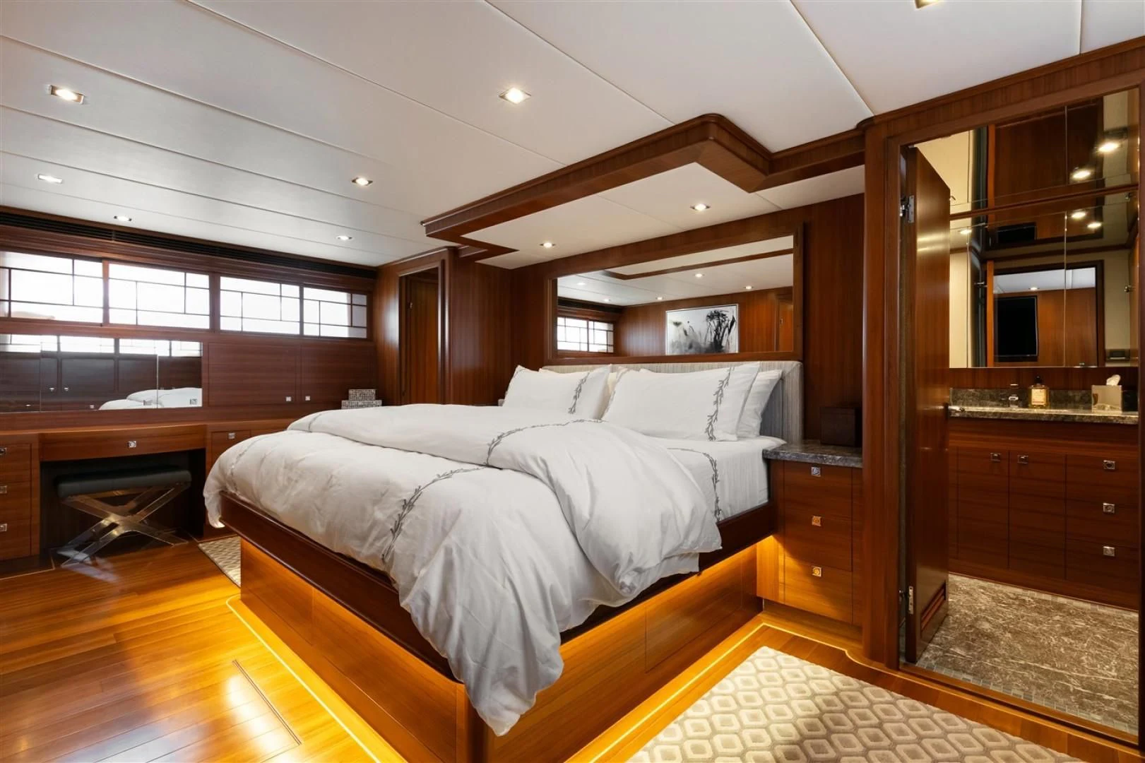 a bedroom with wood furniture aboard BLUE CHIP Yacht for Sale
