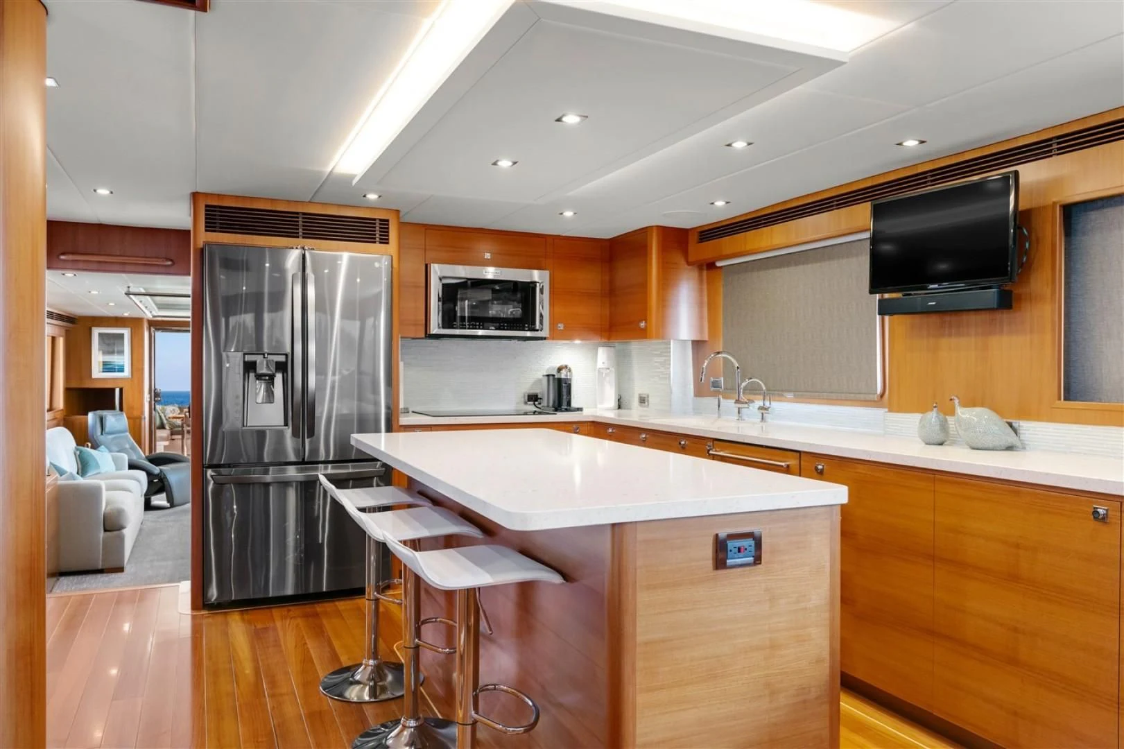a kitchen with a refrigerator and a bar aboard BLUE CHIP Yacht for Sale