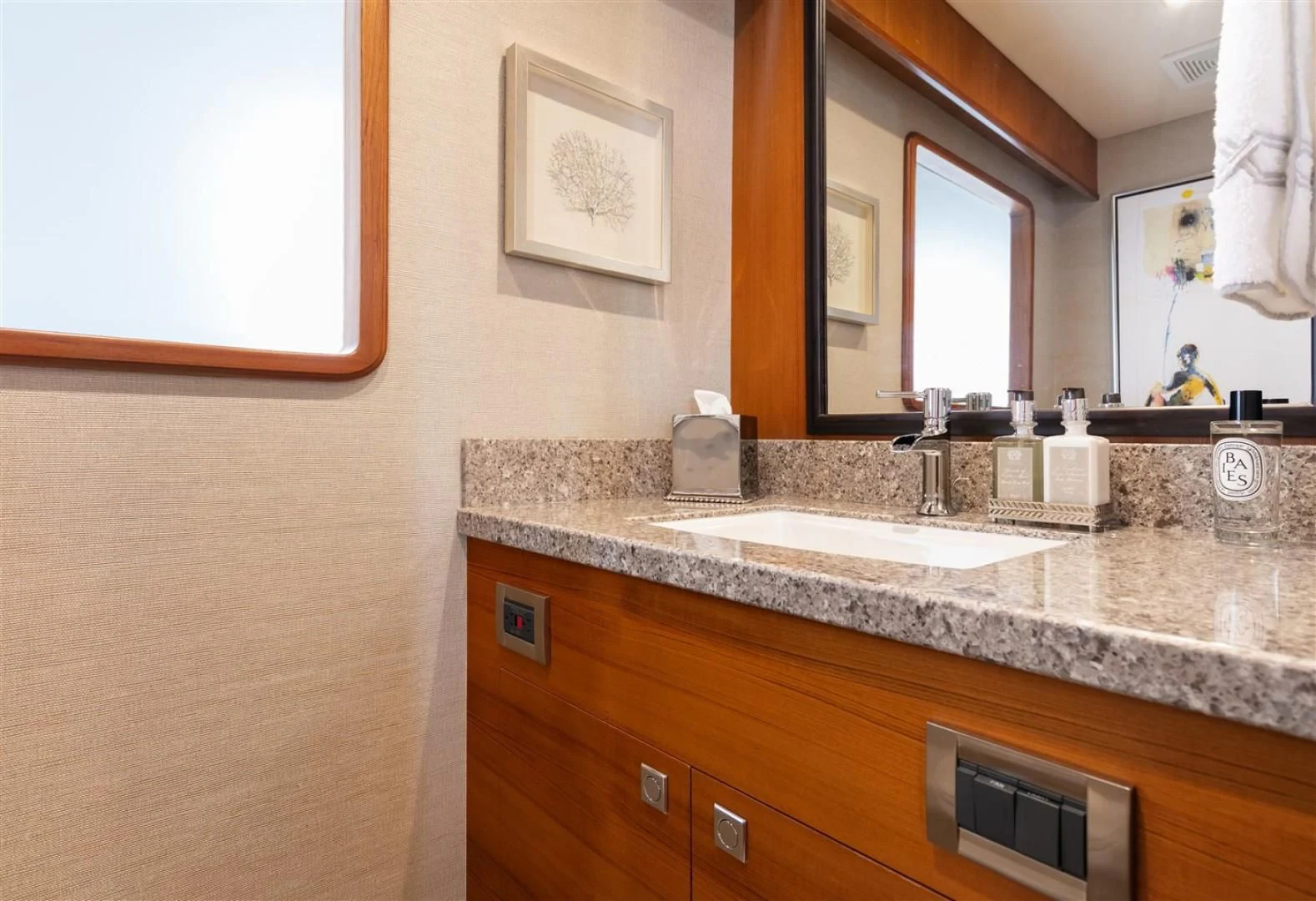 a bathroom with a countertop sink and a mirror aboard BLUE CHIP Yacht for Sale