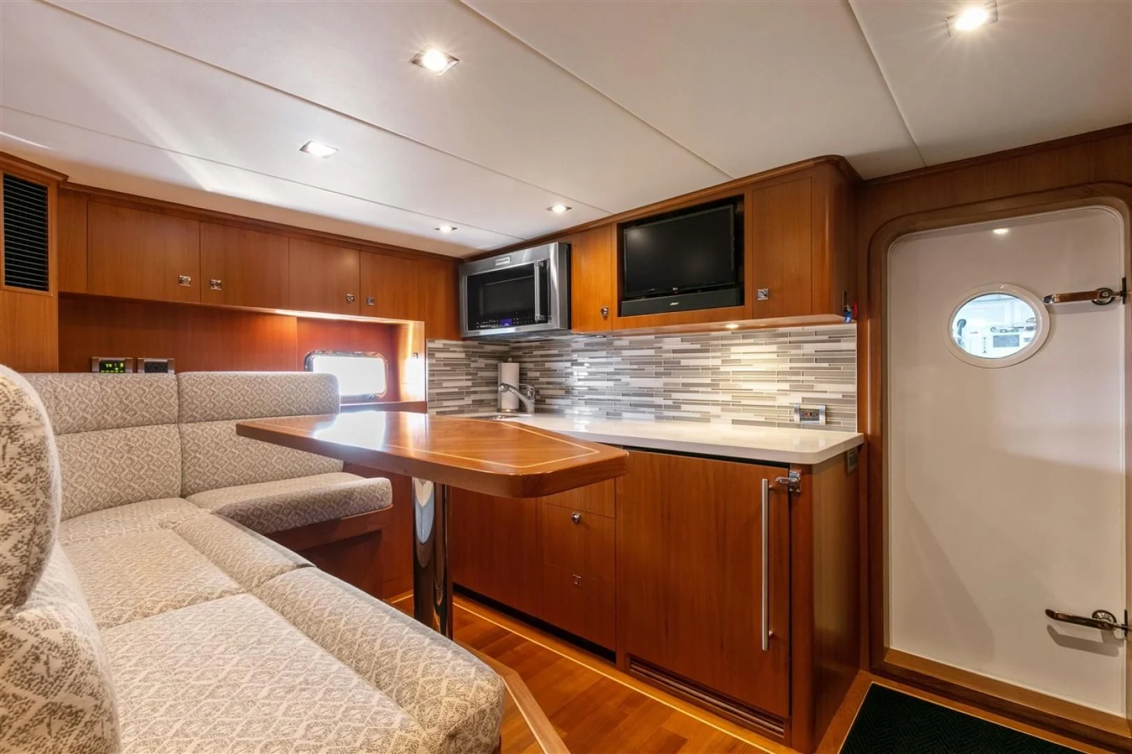 a kitchen with a bar and a couch aboard BLUE CHIP Yacht for Sale