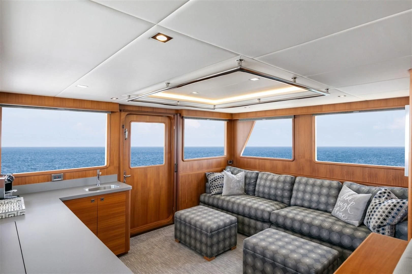 a living room with a couch and a table aboard BLUE CHIP Yacht for Sale
