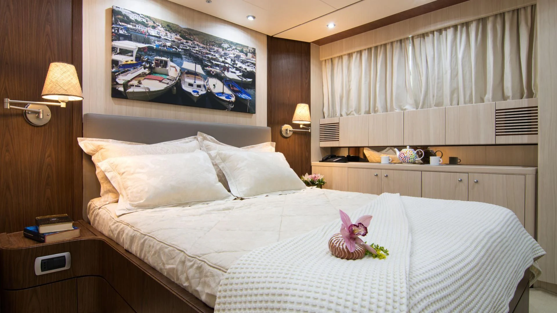 a bedroom with a bed and a television on the wall aboard ACIONNA Yacht for Sale