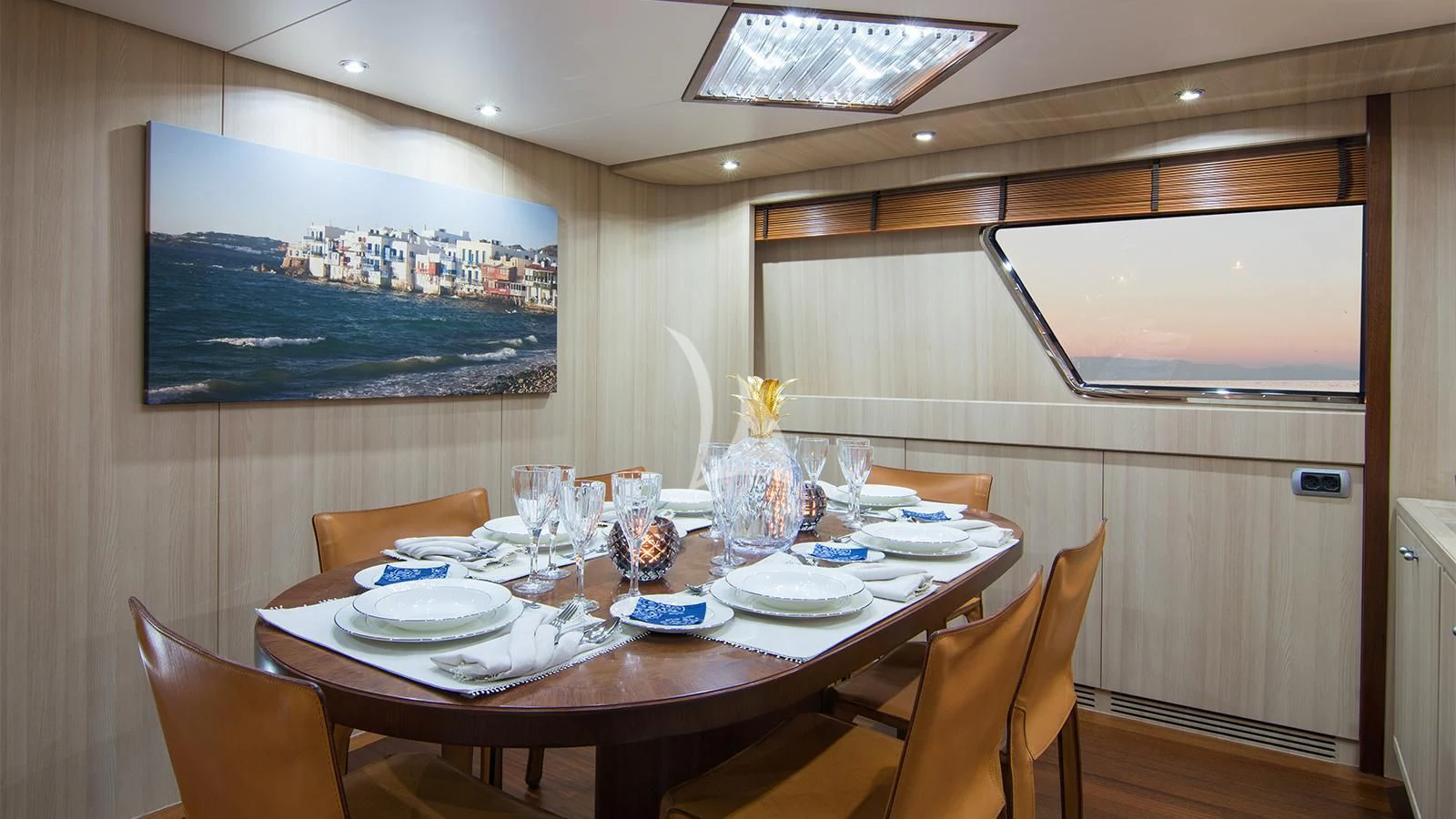 a dining table with plates and glasses aboard ACIONNA Yacht for Sale