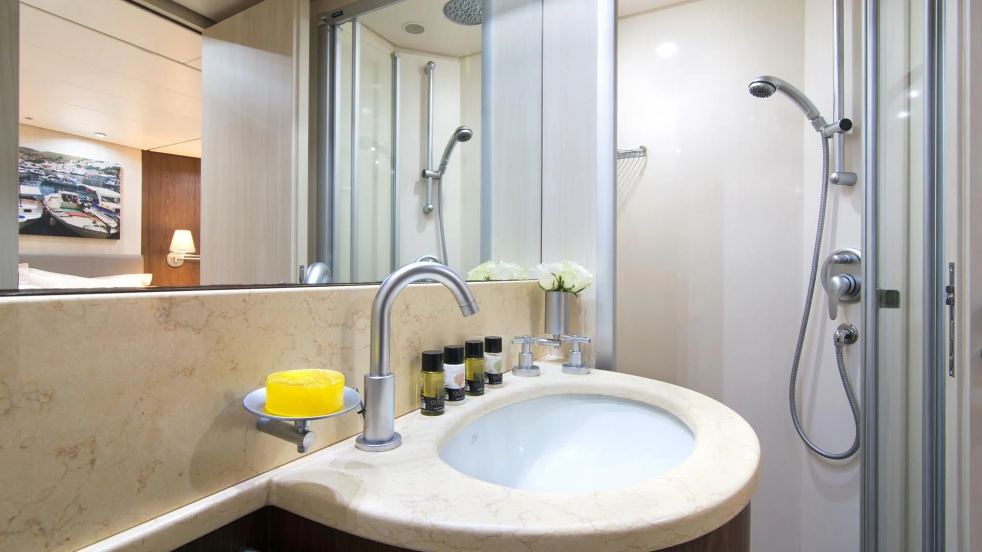 a bathroom with a shower sink and a mirror aboard ACIONNA Yacht for Sale