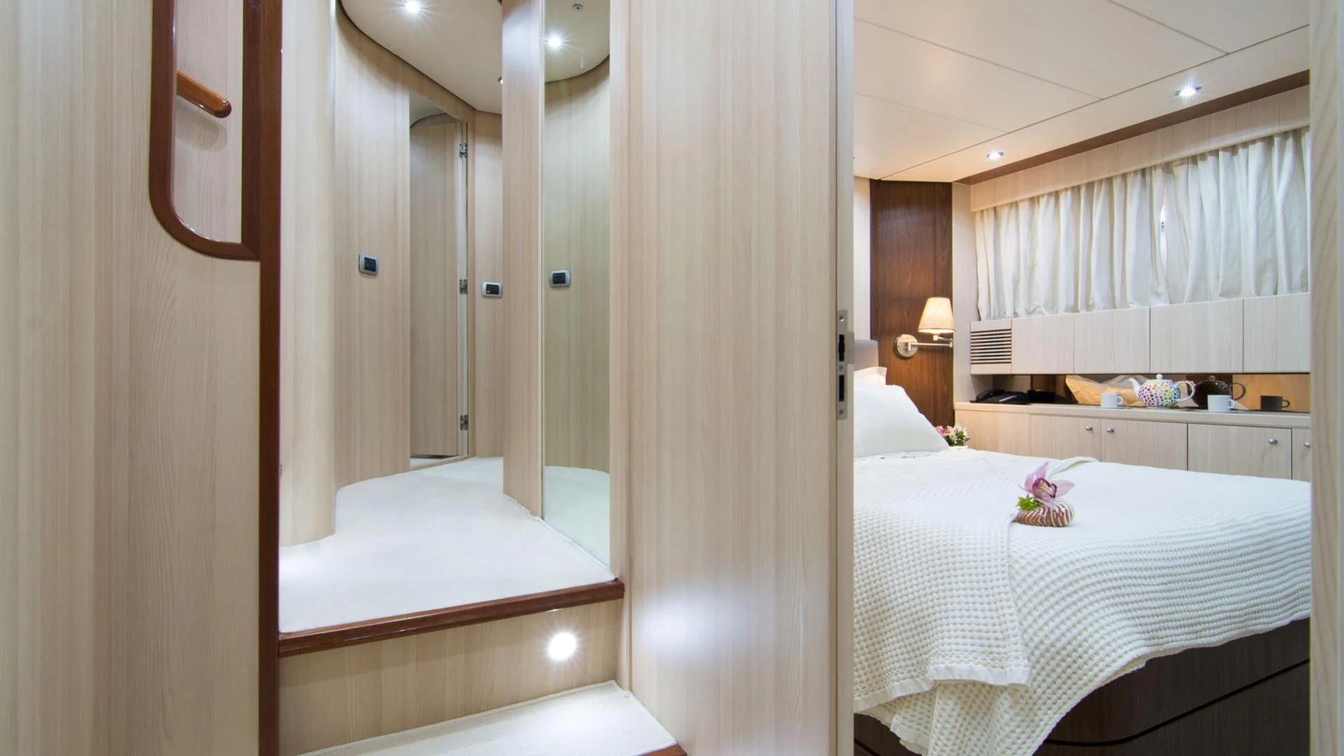a room with a bed and a mirror aboard ACIONNA Yacht for Sale