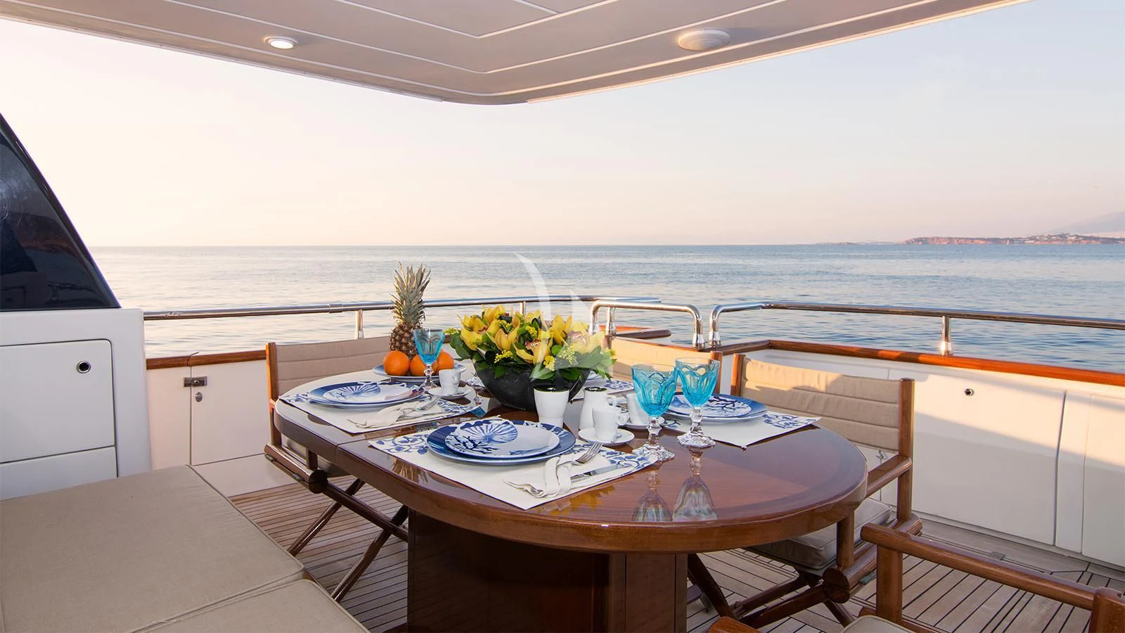 a table with plates and cups on it aboard ACIONNA Yacht for Sale