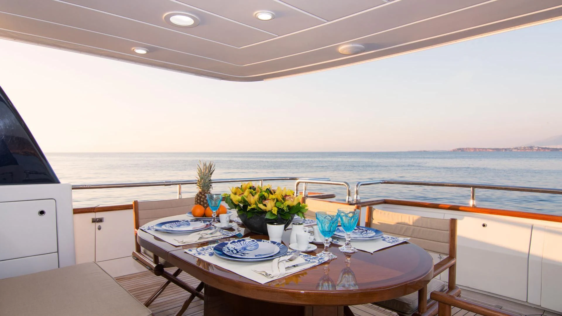 a table with plates and cups on it aboard ACIONNA Yacht for Sale