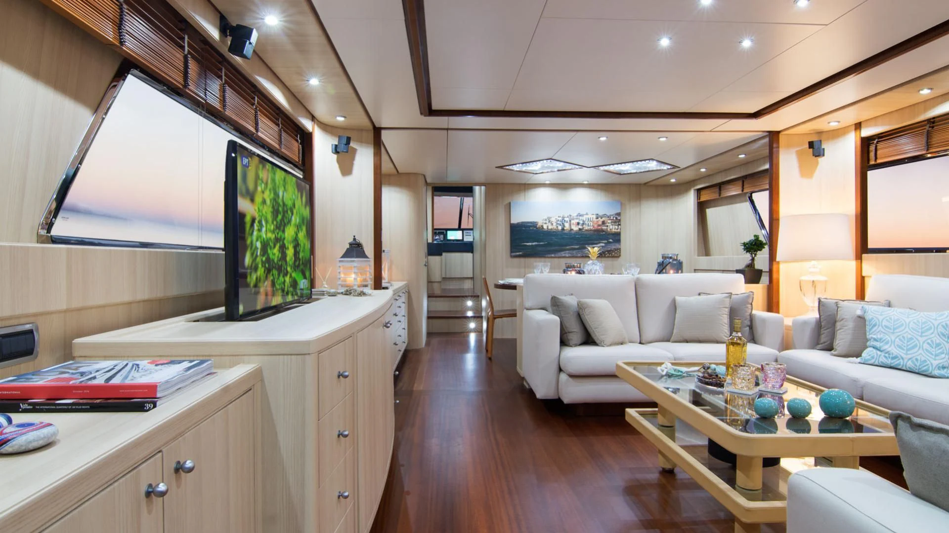 a living room with a table and couches aboard ACIONNA Yacht for Sale