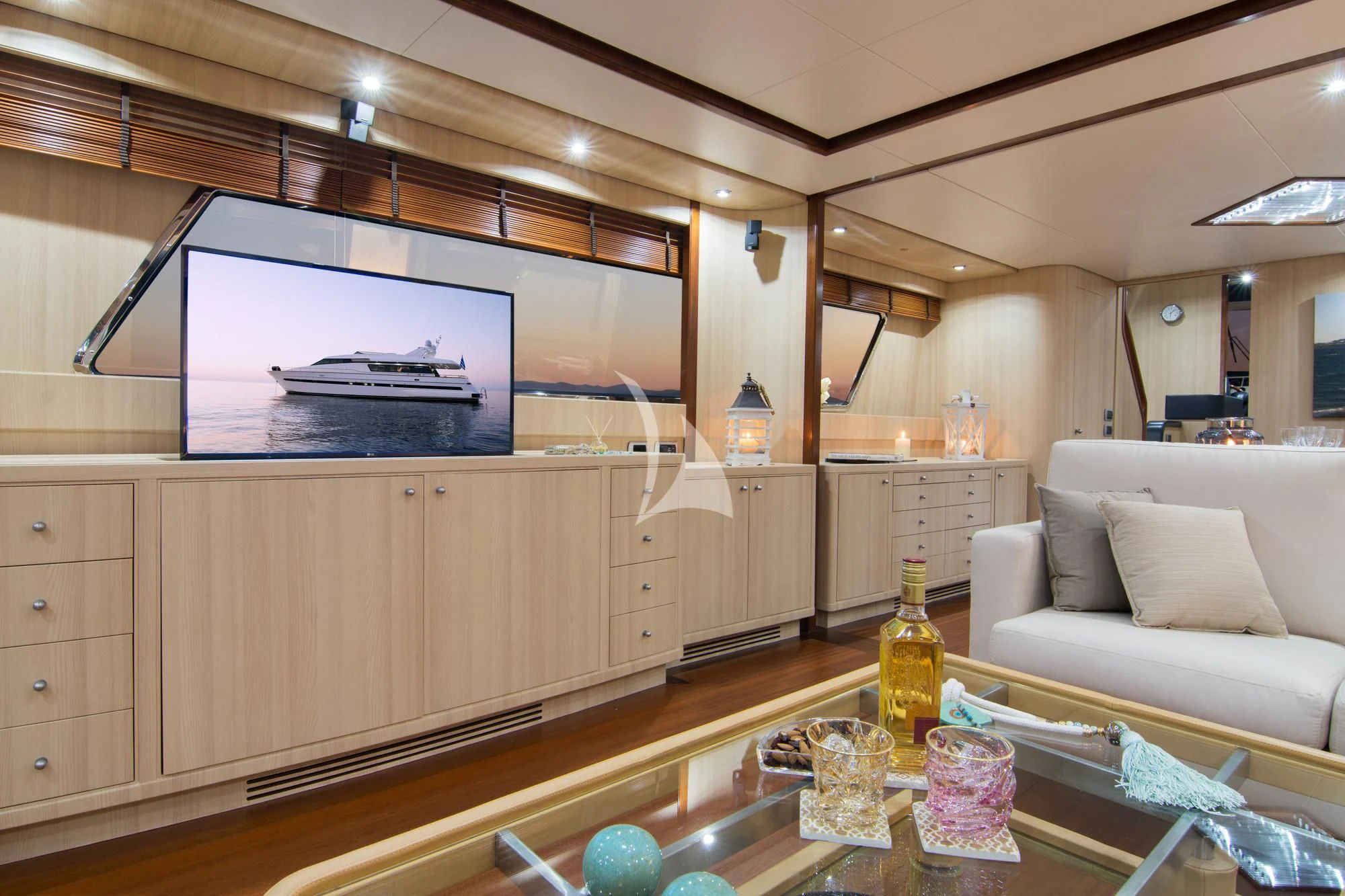 a kitchen with a table and a tv aboard ACIONNA Yacht for Sale