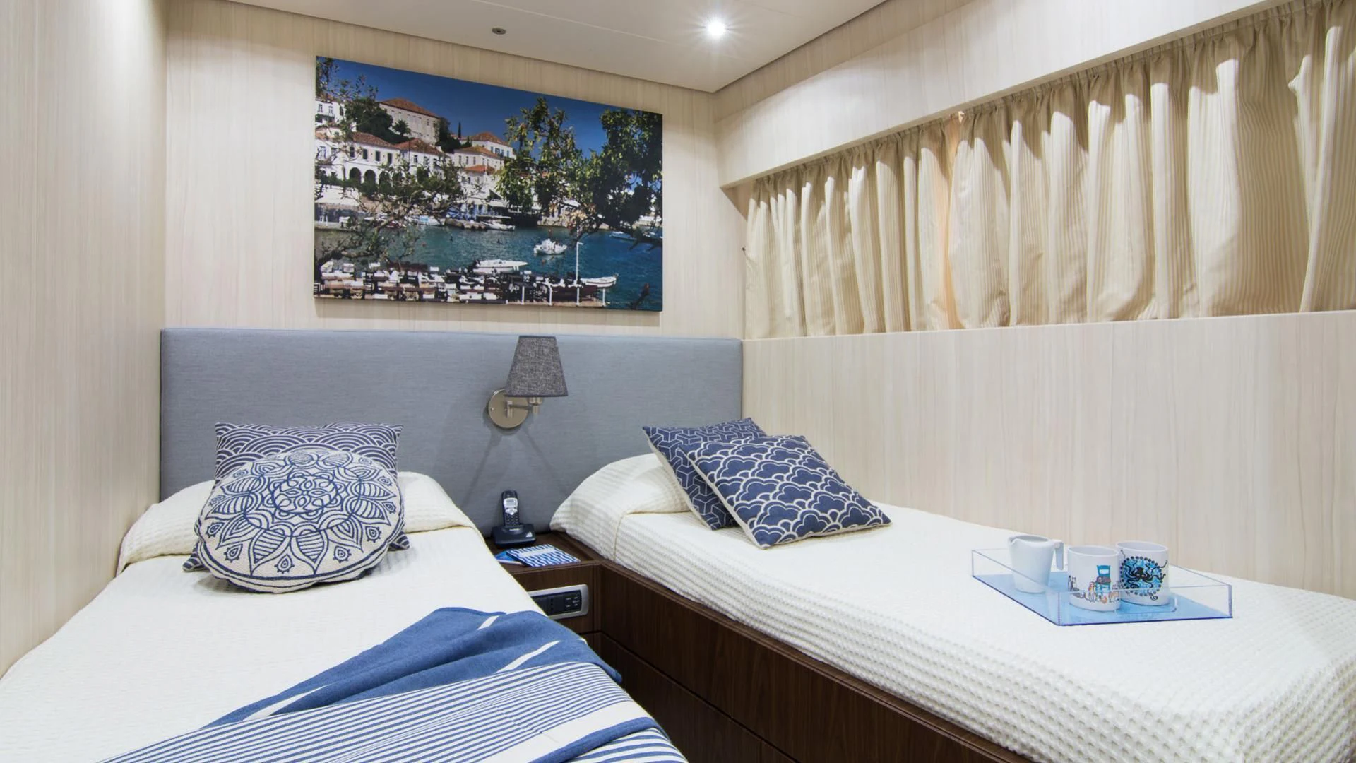 a hotel room with a bed and a painting on the wall aboard ACIONNA Yacht for Sale