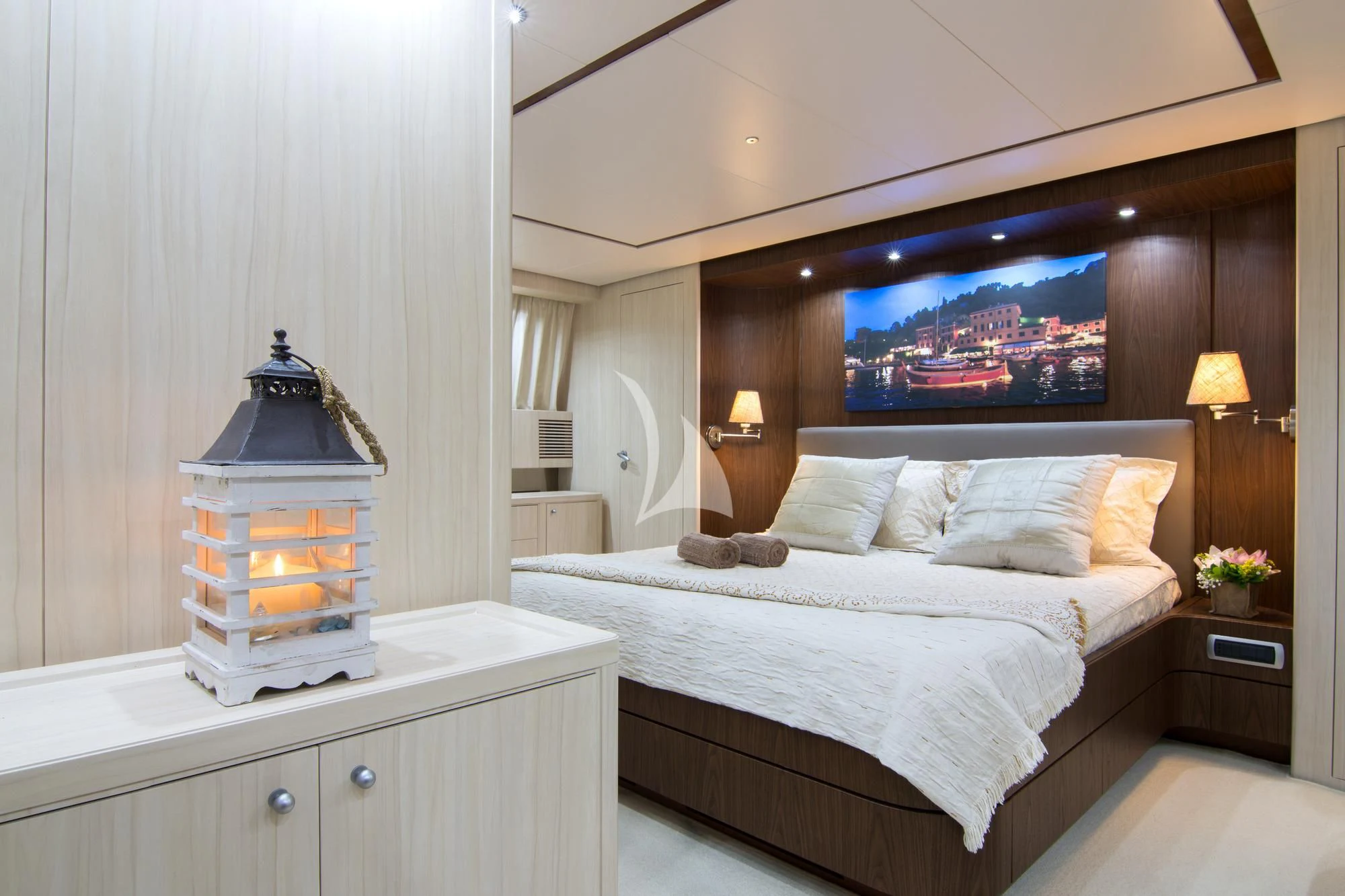 a bed with a lamp on top aboard ACIONNA Yacht for Sale